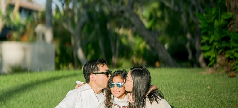 Family enjoying a quiet moment together in the tropical gardens of InterContinental Bali Resort