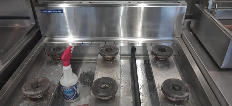a stove top with a bottle of liquid on it