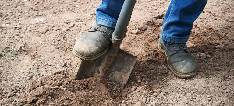 Simple shovel and shoes in the dirt