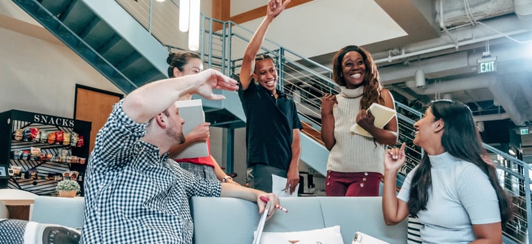 a group of young professionals smiling in celebration