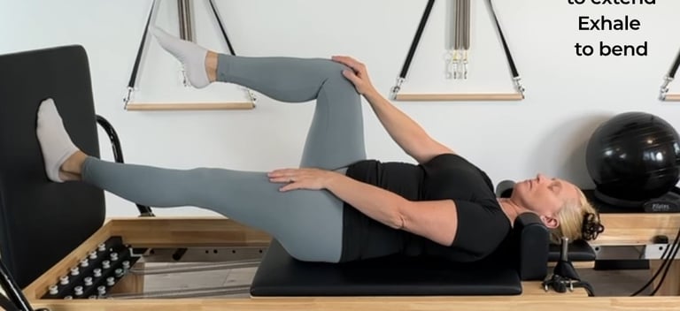 a woman showing how to work on a reformer
