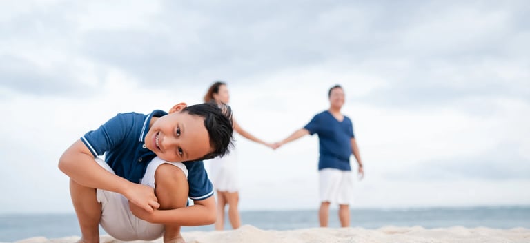 Playful family moment on the beach at The Mulia Nusa Dua Bali