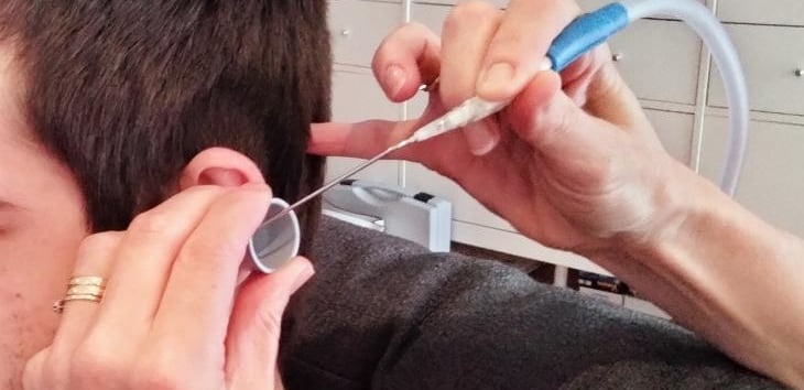 A client having ear wax removal with microsuction
