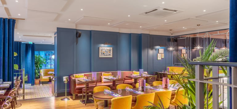 a restaurant with a large table and chairs