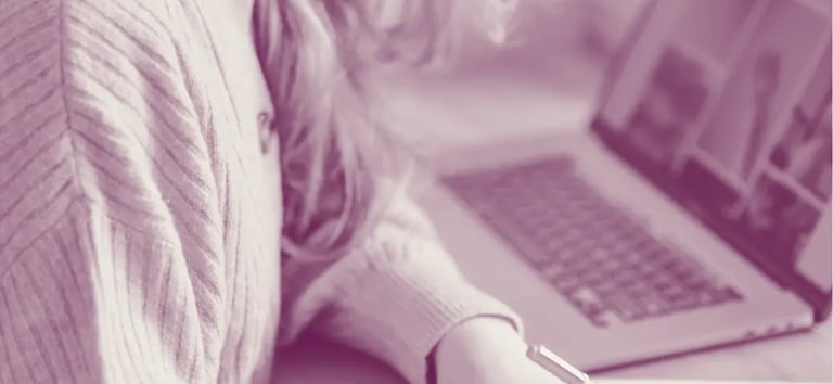 A woman working at her desk for Excellence