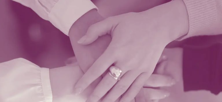 Women holding hands together for Trust