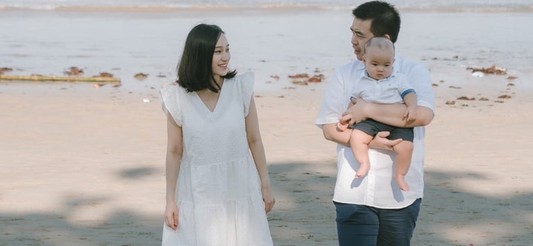 Family walking along the beach at Intercontinental Jimbaran during a calm and natural Bali family photography session