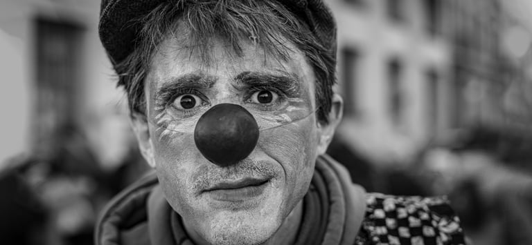 a man with a clown nose and nose paint on his face