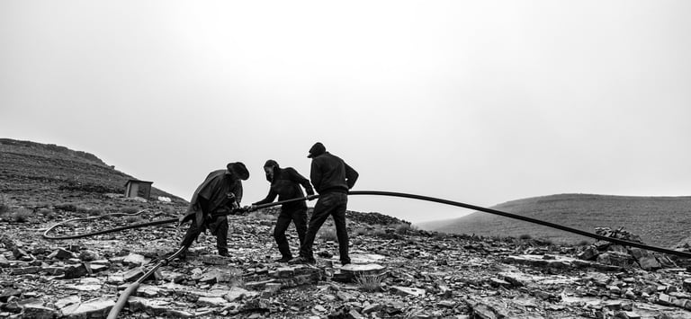 a group of men working on a mountain