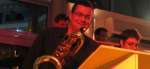a man playing a saxophone and a saxophone