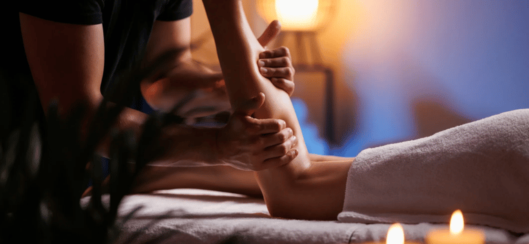 Someone getting their calf muscles massaged.