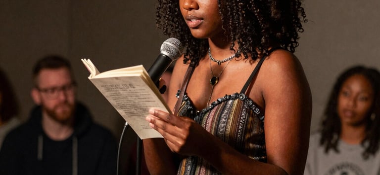 A warm, intimate photo of the author writing by a window with soft golden light filtering through.
