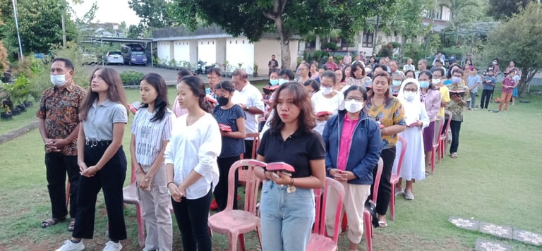 a group of people standing in a line of chairs