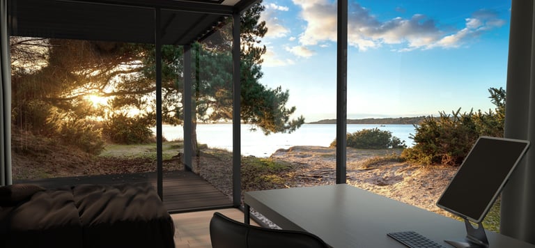 Cozy bedroom inside the Mirrored Cabin with natural morning light