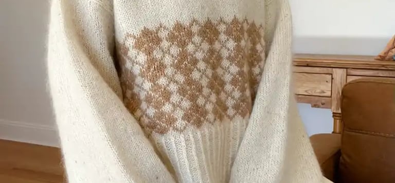 Paddock and Purl Studio Instructor Marie wearing a beautiful hand knit in cream and brown she created