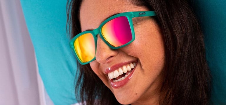 Woman smiling wearing bright polarized sunglasses