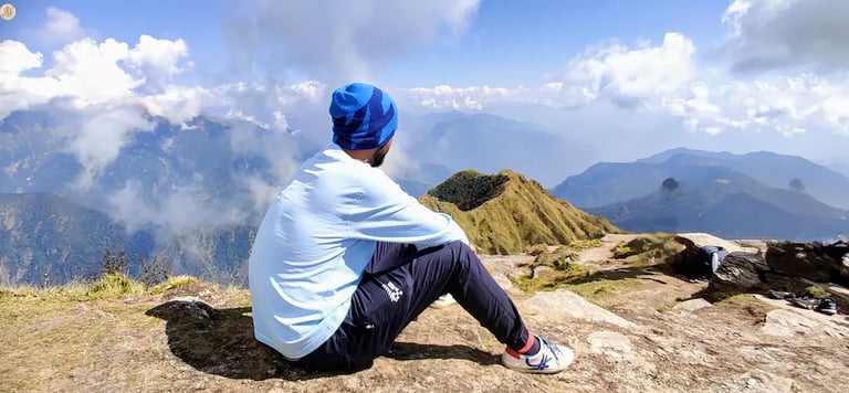View from Chandrashila Summit, Uttarakhand Himalayas, panoramic snow-capped peaks and sky.