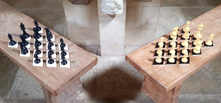 Thirty-two lozenge tiles, half black, half white, holding chess pieces