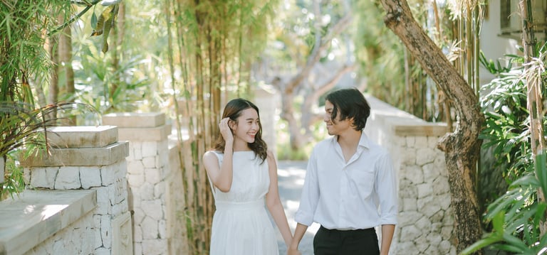 Intimate couple walking through the garden during a photography session at Novotel Bali Benoa in Tanjung Benoa Bali.