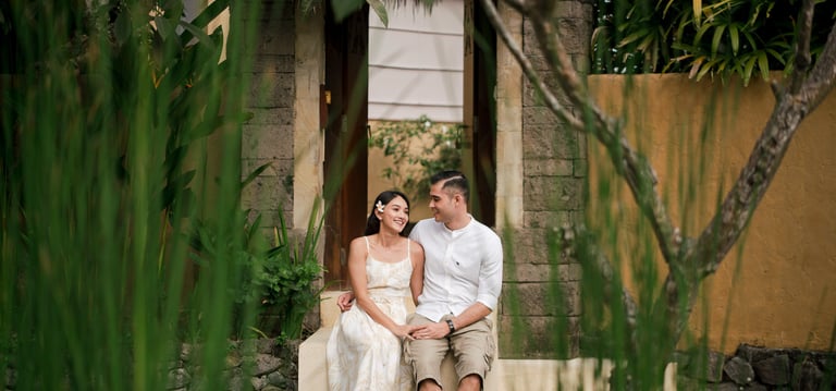 Romantic couple seated together in tropical garden at Waka Gangga West Bali