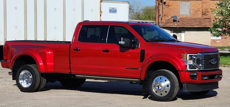 a red  ford truck parked in lot after being detailed ceramic coating
