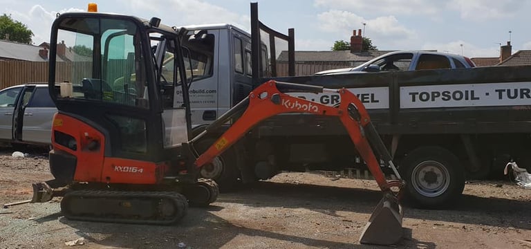 CMR digger in front of a pickup truck preparing for delivery in Dudley