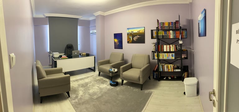 a living room with a chair and a desk