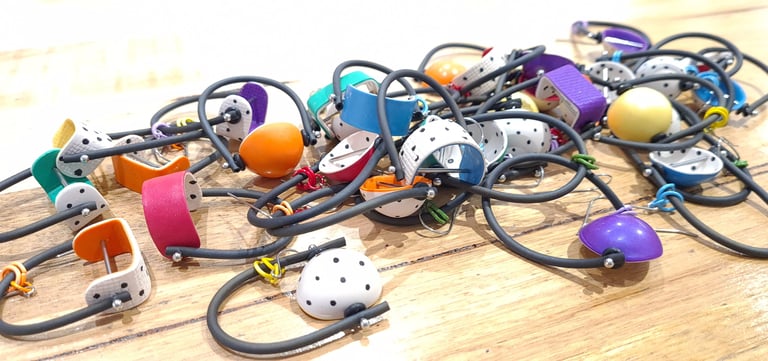 a bunch of different colored earrings on a table