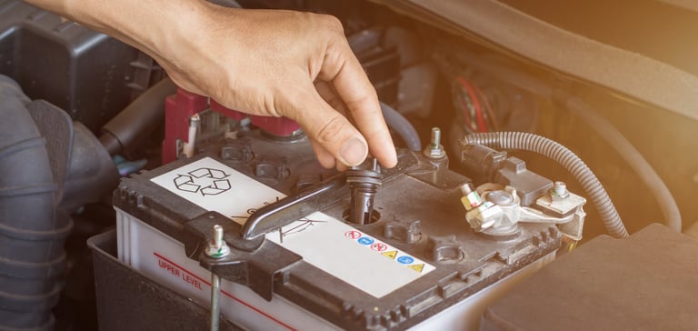 a person is holding a battery in their hand