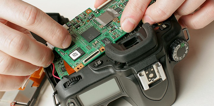 Camera technician removes faulty PCB