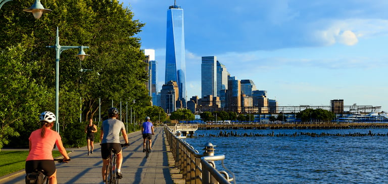 Cyclists riding beside the river on the Hudson River Greenway in New York