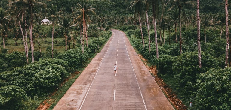 a person riding a bike down a road
