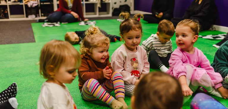 Young children as friends,sitting together watching farmer Becca in class.