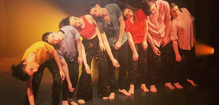 a group of people standing in a line of dancers