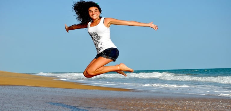 Woman jumping on the beach