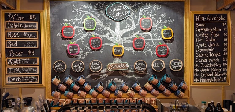 Rustic cider bar menu featuring chalk drawings, cider flight options, wine, and beer on tap.