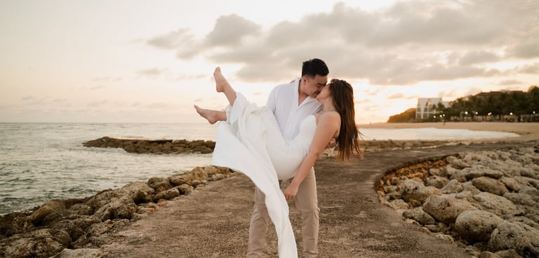Couple embracing during golden sunset beach prewedding photoshoot at Apurva Kempinski Bali