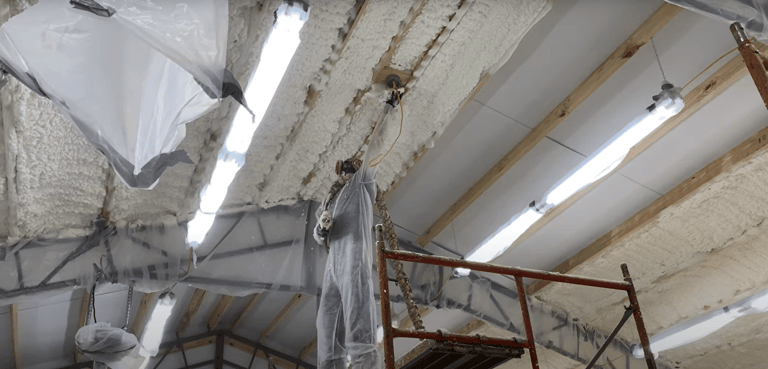 worker using spray foam gun