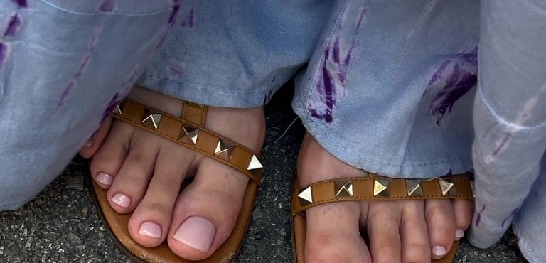 a person wearing sandals and a pair of sandals