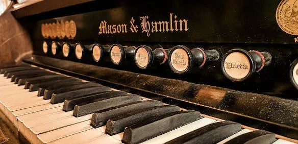 Lafayette - An 1800's piano in the grand hallway at the Marsh House