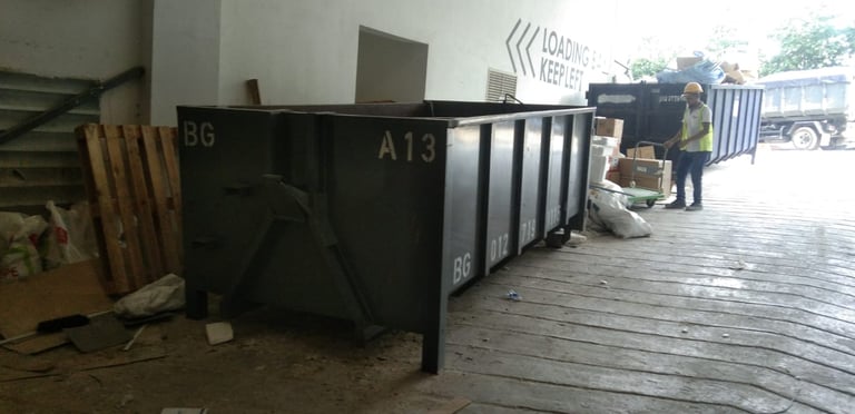 a man standing in front of a large metal container