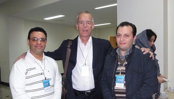 three men standing next to each other in a room