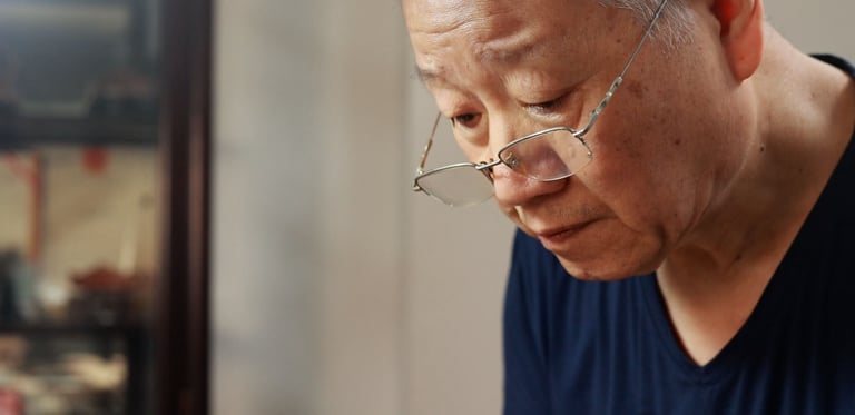 Artisan Kuai Liangrong crafting a teapot
