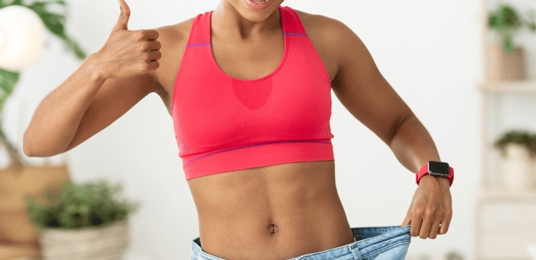 a woman in a pink bra top and jeans jeans