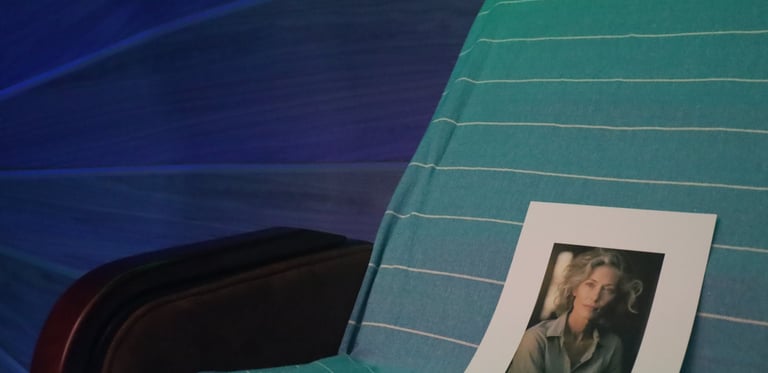 Chair with a picture of a woman showcasing a remote bio-energy therapy session.