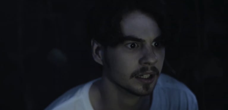 a man with a mustache and a white shirt