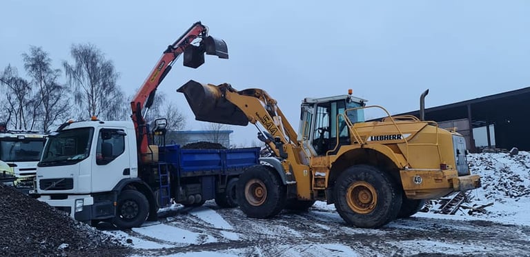 CMR digger loading topsoil onto grab lorry for local delivery in Dudley
