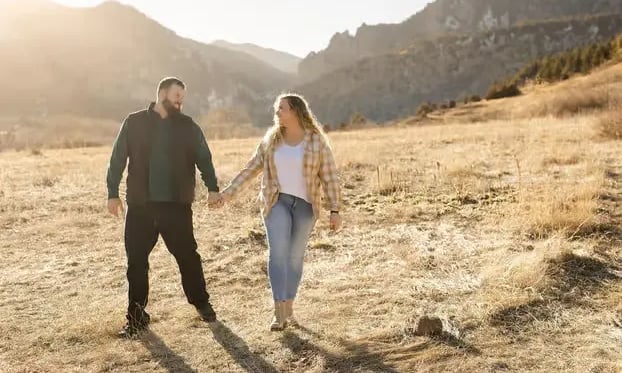 Couple walking on Boulder mountain trail during professional Colorado photoshoot session
