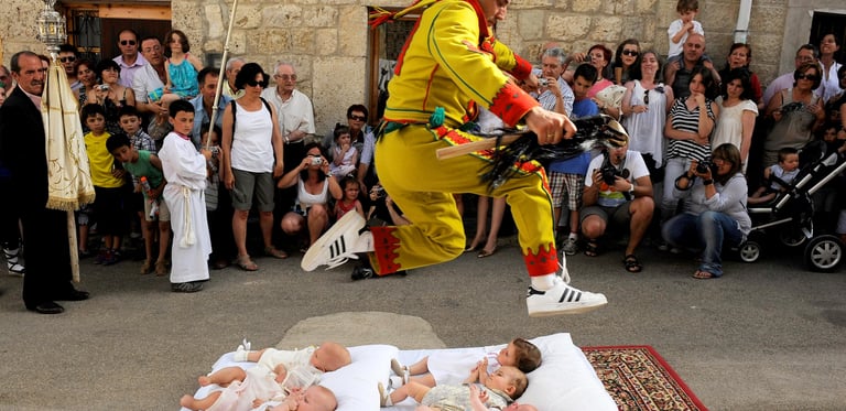 El Colacho jumping over babies during the traditional baby jumping festival in Castrillo de Murcia, Spain.