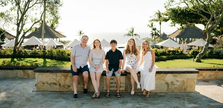 Family portrait surrounded by tropical gardens during a family photography session at AYANA Resort Bali
